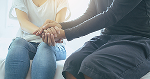 Man giving hand to depressed woman