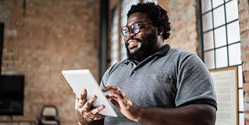 Man reading a newsletter on tablet