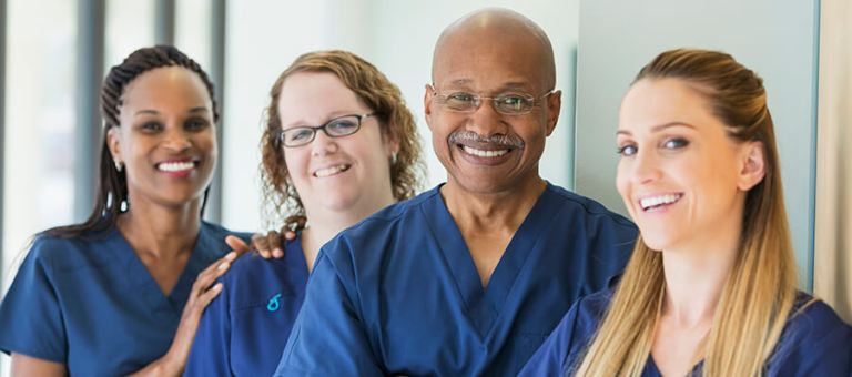 Group of smiling health and human services nurses.