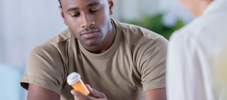 Patient looking at medication given to them by a doctor.